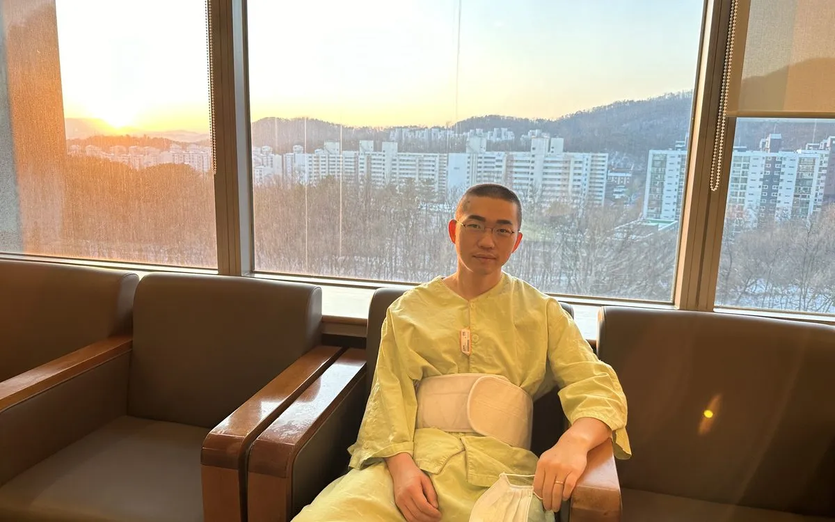 David during recovery, by a hospital window